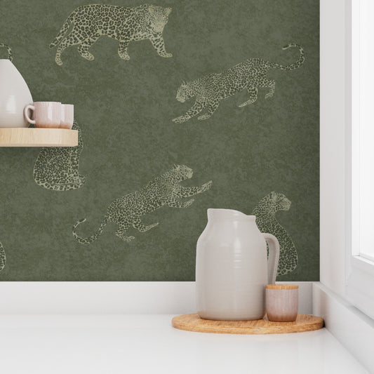 Kitchen scene with Cheetah Tadelakt wallpaper in moss featuring leaping cat illustrations, white pitcher, and pink cups.