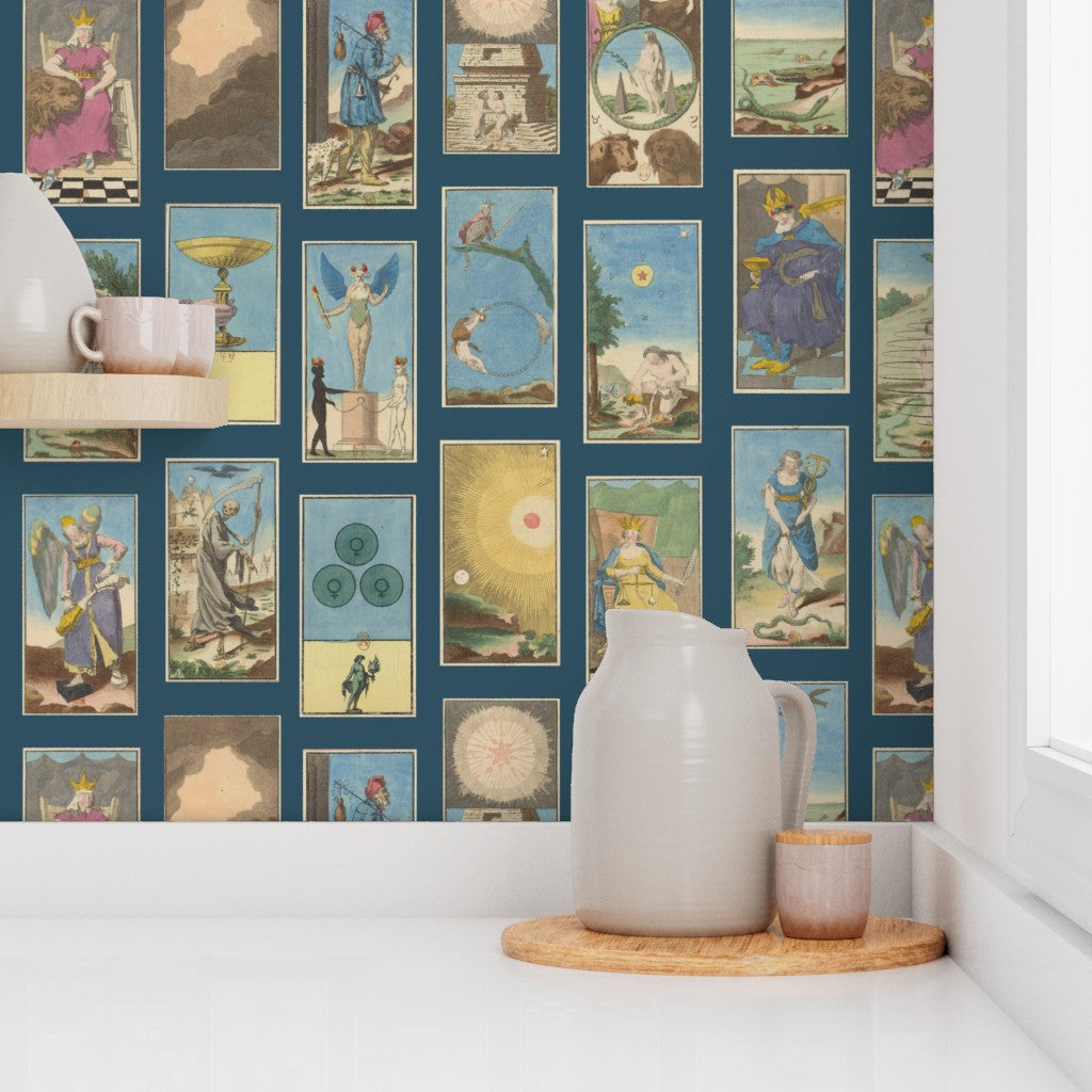 a decorative wall with tarot card-themed wallpaper, white pitcher, and wooden tray on a shelf