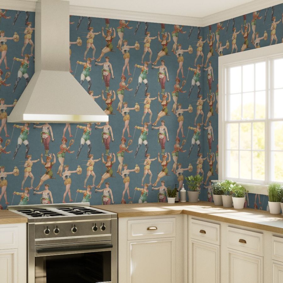 kitchen featuring wallpaper with white cabinets and a window.