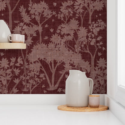 White pitcher on a wooden tray against the burgundy shade of the garden tapestry wallpaper.
