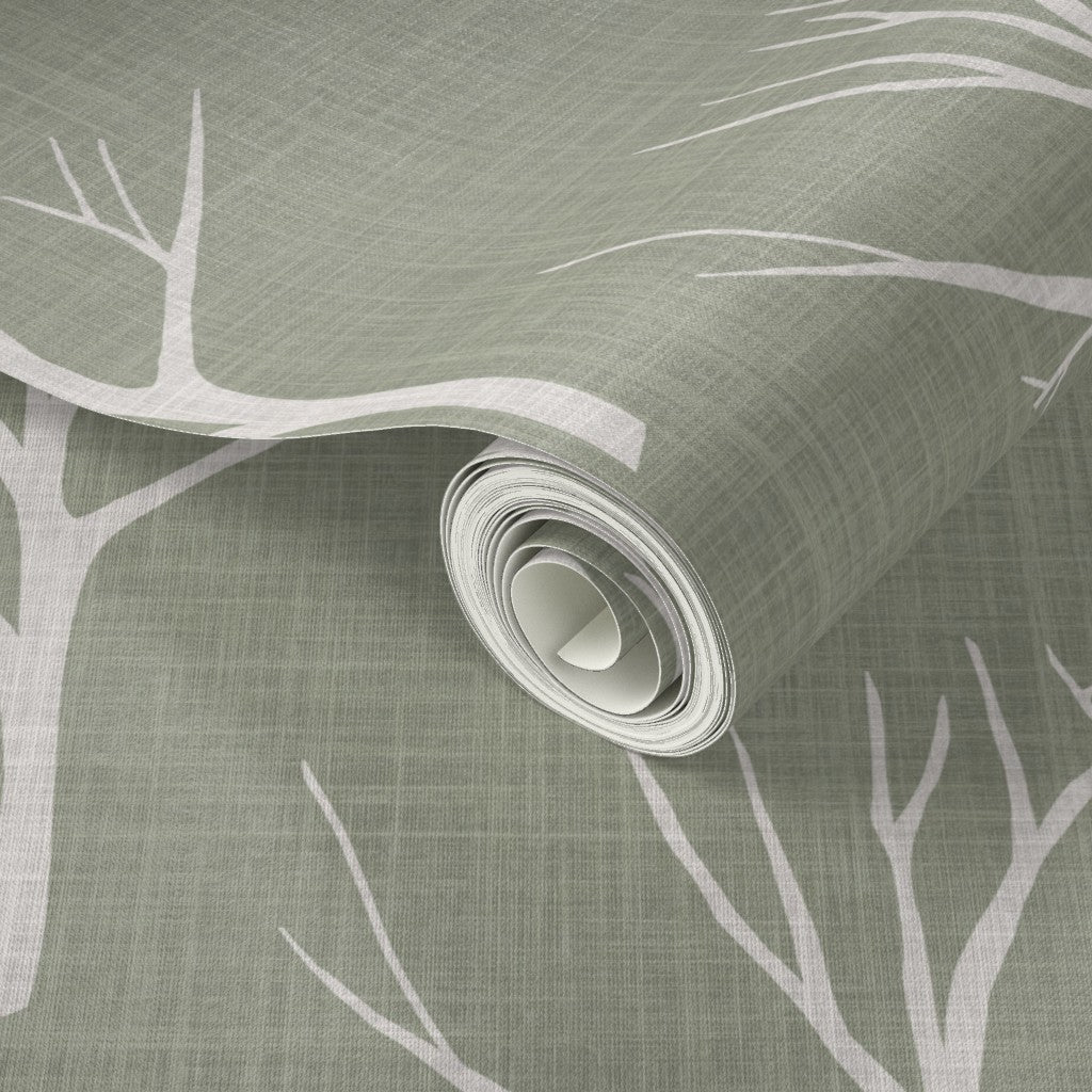 Roll of wallpaper with tree branch design on a textured green background