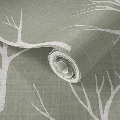 Roll of wallpaper with tree branch design on a textured green background