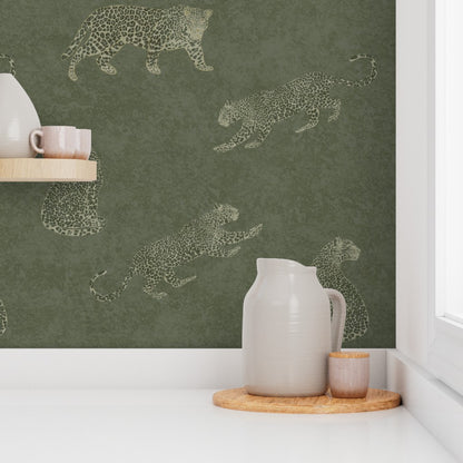 Kitchen scene with Cheetah Tadelakt wallpaper in moss featuring leaping cat illustrations, white pitcher, and pink cups.