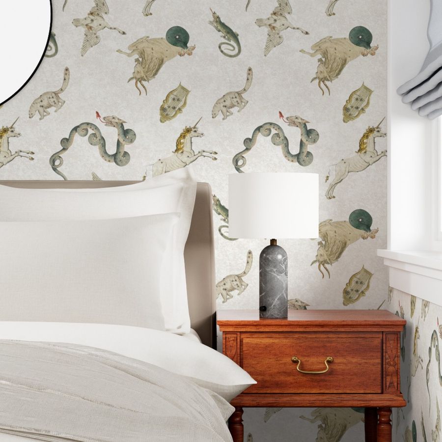 a bedroom with a made bed, side table, and lamp to showcase wallpaper