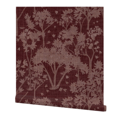 Partially rolled wallpaper with a pink garden pattern on a burgundy background