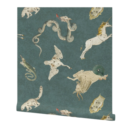partially rolled wallpaper patterned with illustrations of mythical creatures on a teal background