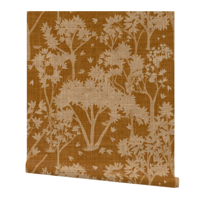 partially rolled wallpaper with a light orange garden pattern on a burnt orange background