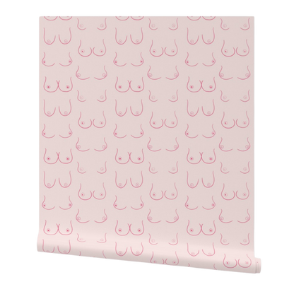 partially rolled wallpaper with magenta hand drawn linework-style illustrations of boobs on a light pink background