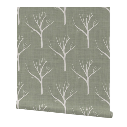 Roll of wallpaper with white tree branches on a green background